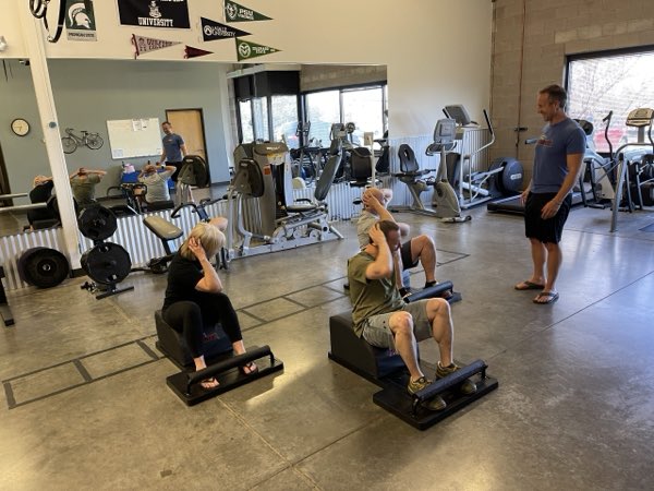 Trainer Joe leading a group core session on The Answer® benches.